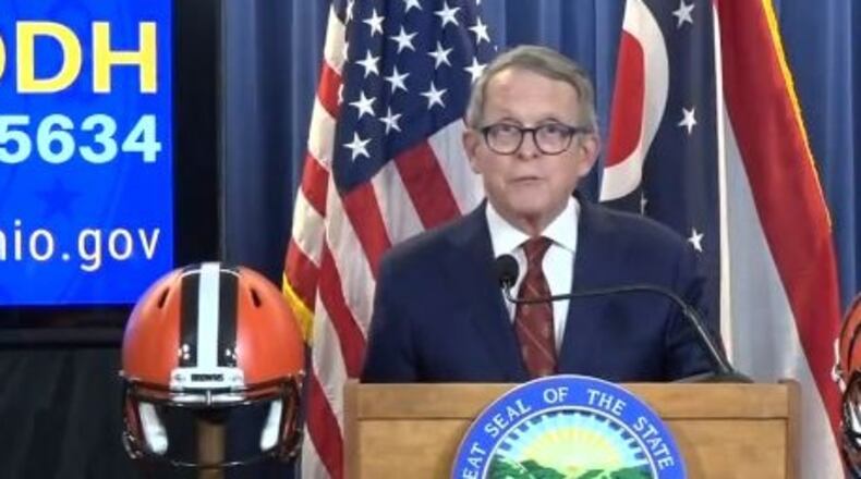 Ohio Gov. Mike DeWine had football helmets representing the state’s two NFL teams on either side of the dais during a daily press conference on the coronavirus situation Thursday, April 23, 2020. A Cleveland Browns helmet was to his right, and a Cincinnati Bengals helmet was to his left. The NFL draft was to begin Thursday evening.