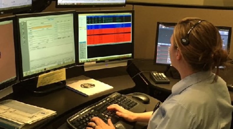 The Centerville Police Department dispatch center handles calls for the city of West Carrollton. Centerville and Kettering are connected by fiber optics, which includes a 911 system. The Miami Valley Communications Council is looking to further joint efforts among its members by implementing a fiber optics ring involving several cities. NICK BLIZZARD/STAFF PHOTO