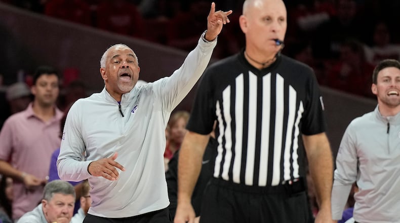 Kansas State head coach Jerome Tang, center left, reacts on the sideline during the second half of an NCAA college basketball game against Houston, Saturday, Feb. 14, 2026, in Houston. (AP Photo/ Karen Warren)