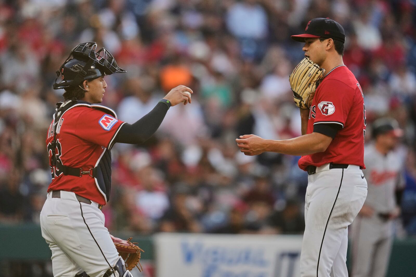 Cleveland Guardians catcher Bo Naylor, left, walks out to talk with pitcher Joey Cantillo, right, in the fifth inning of a baseball game against the Baltimore Orioles in Cleveland, Tuesday, July 22, 2025. (AP Photo/Sue Ogrocki)