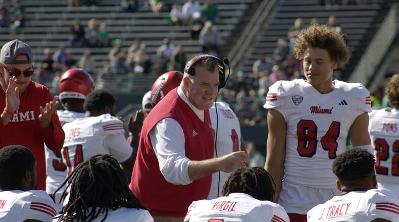 Miami head coach Chuck Martin celebrates an early touchdown with Reggie Virgil in the RedHawks game against Eastern Michigan on Oct. 12. Kasey Turman/CONTRIBUTED