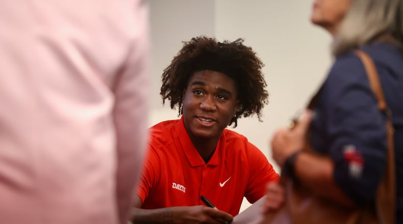 Dayton's Marvel Allen talks to a fan during a meet and greet and autograph session on Wednesday, Oct. 9, 2024, at UD Arena. David Jablonski/Staff