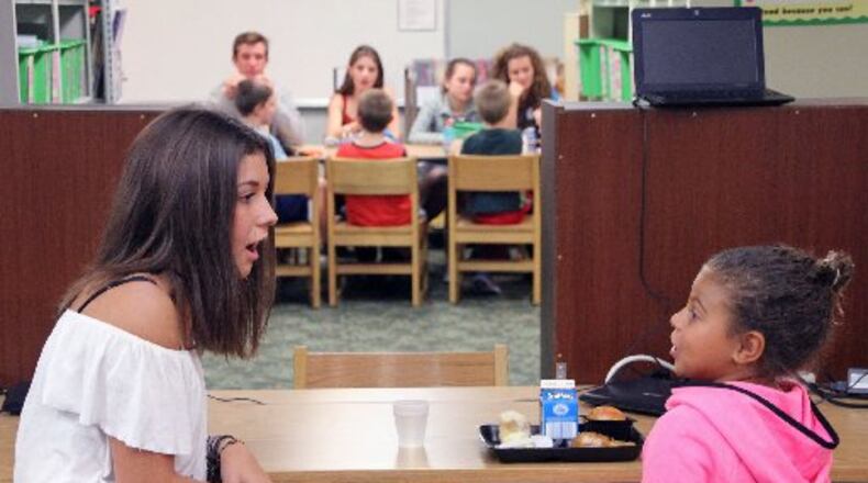 Centerville High School students spend lunch time with Cline Elementary students as part of the “Lunch Buddies” program. Centerville City Schools’ state funding would follow an odd pattern if Gov. John Kasich’s budget plan became law. CONTRIBUTED PHOTO