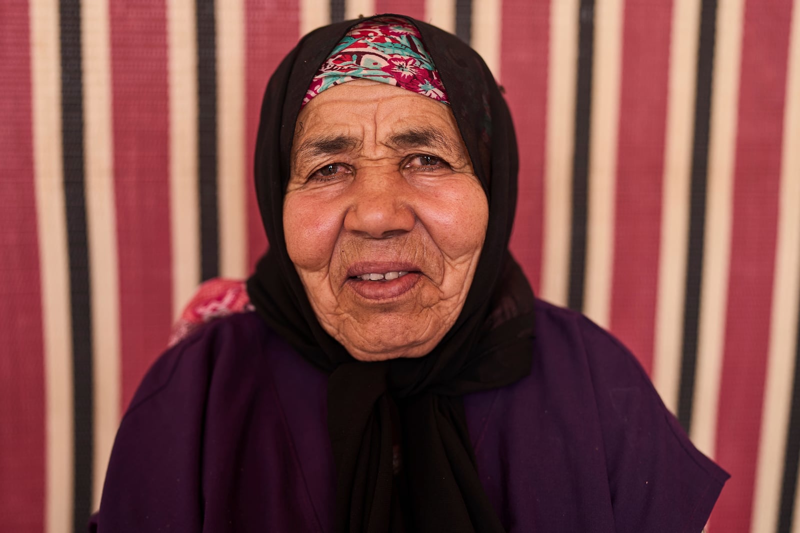 Lalla Fatouma Boulkmah, who works at a cooperative that extracts and produces argan oil and products, poses for a portrait, in Essaouira, Morocco, Thursday, May 22, 2025. (AP Photo/Mosa'ab Elshamy)