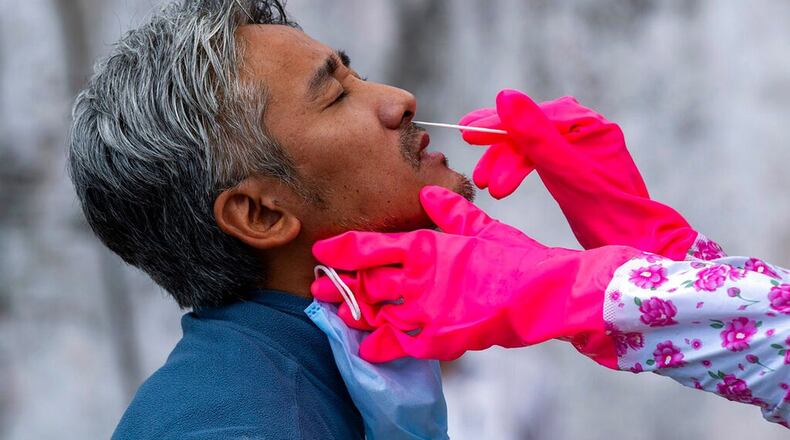 A doctor takes a nasal swab to be tested for the coronavirus in Dharmsala, India, Saturday, May 9, 2020. India relaxed some coronavirus lockdown restrictions on Monday even as the pace of infection picked up and reopenings drew crowds of people. (AP Photo/Ashwini Bhatia) (Ashwini Bhatia/AP)