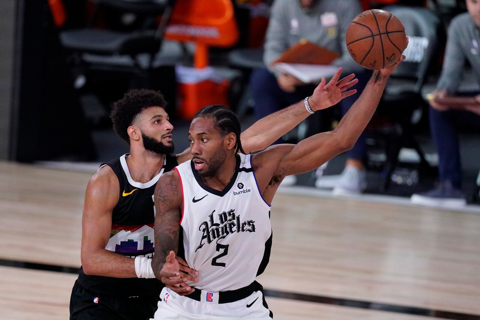 Los Angeles Clippers' Kawhi Leonard (2) is defended by Denver Nuggets' Jamal Murray (27) during the second half of an NBA conference semifinal playoff basketball game, Wednesday, Sept. 9, 2020, in Lake Buena Vista, Fla. (AP Photo/Mark J. Terrill)