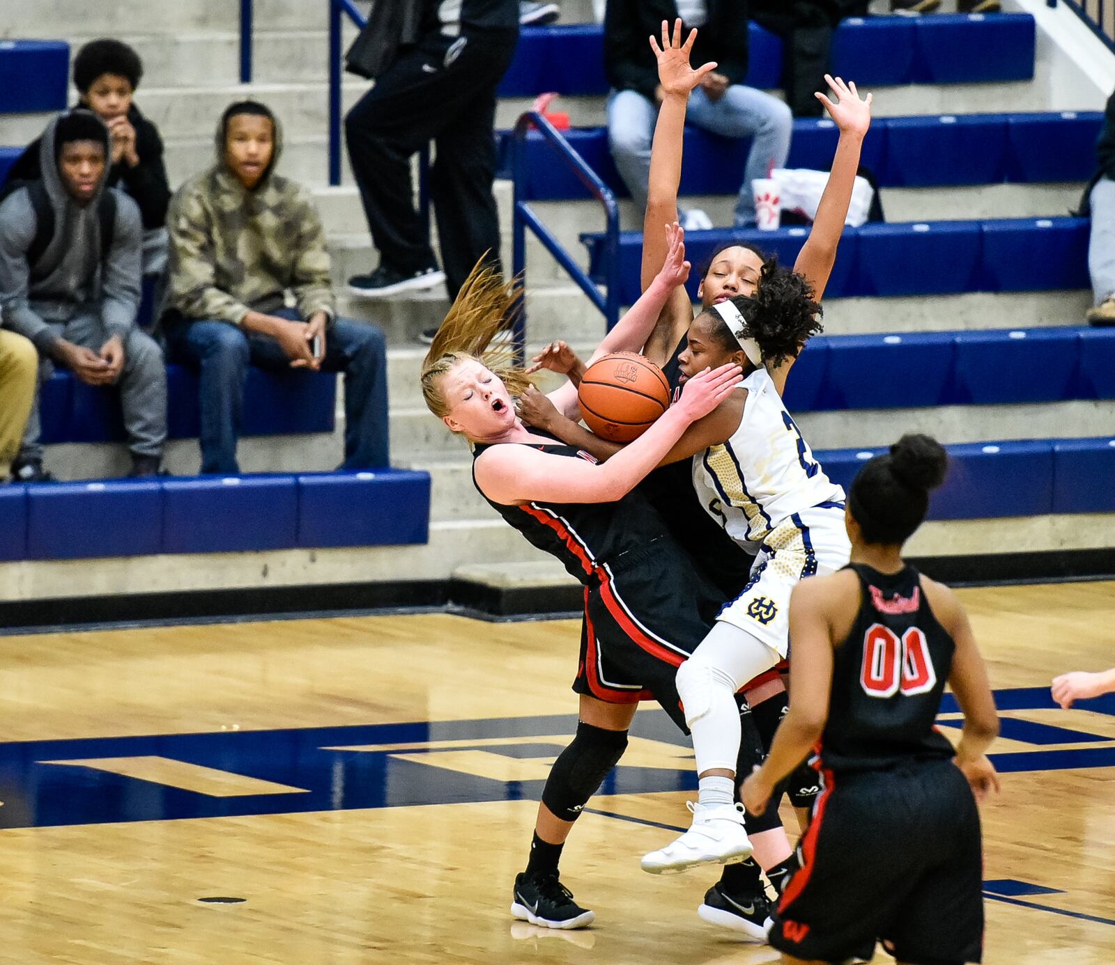 Lakota West's Abby Prohaska is fouled by Walnut Hills' Regan Anderson during their Division I regional semifinal Wednesday night at Fairmont’s Trent Arena. NICK GRAHAM/STAFF