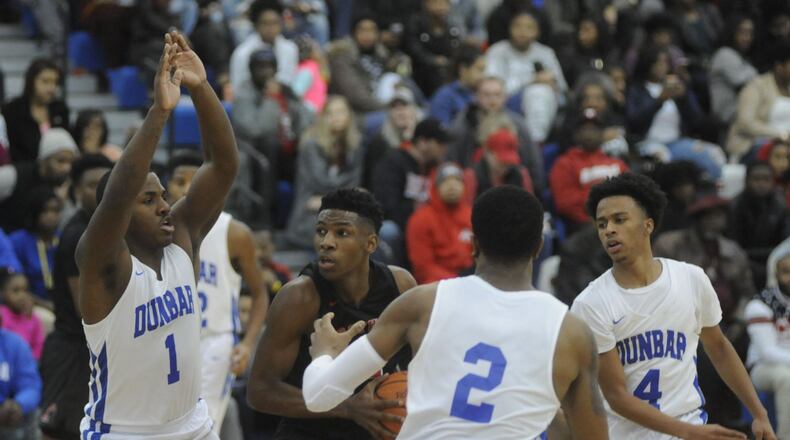 Trotwood’s Carl Blanton (with ball) is surrounded by dunbar’s Tavion thomas (1), Joseph Scates (2) and Phile Hardwood. Trotwood-Madison defeated host Dunbar 80-64 in a boys high school basketball game on Sat., Feb. 3, 2018. MARC PENDLETON / STAFF