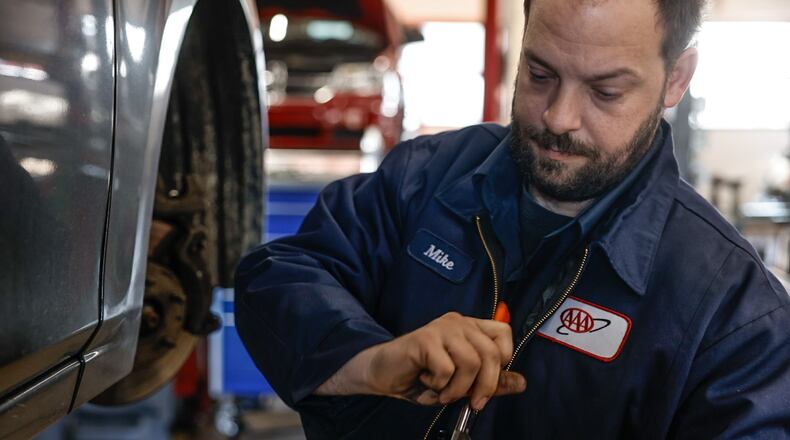 AAA auto mechanic Michael Mollett replaces brakes at the service center in Beavercreek Thursday, March 28, 2024. Auto repair is a good industry for workers to be in right now, said Dan Scroggins, vice president of personal lines insurance at AAA. Wages are up significantly over the last three years, and there is a ton of work, Scroggins said.  JIM NOELKER/STAFF