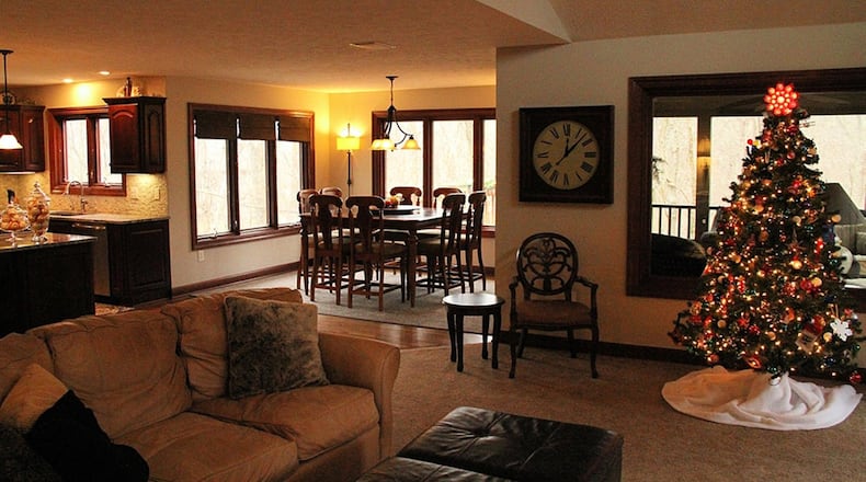 Windows surround the breakfast room on 3 sides to take in the wooded view, and sliding glass doors open to the screened porch.