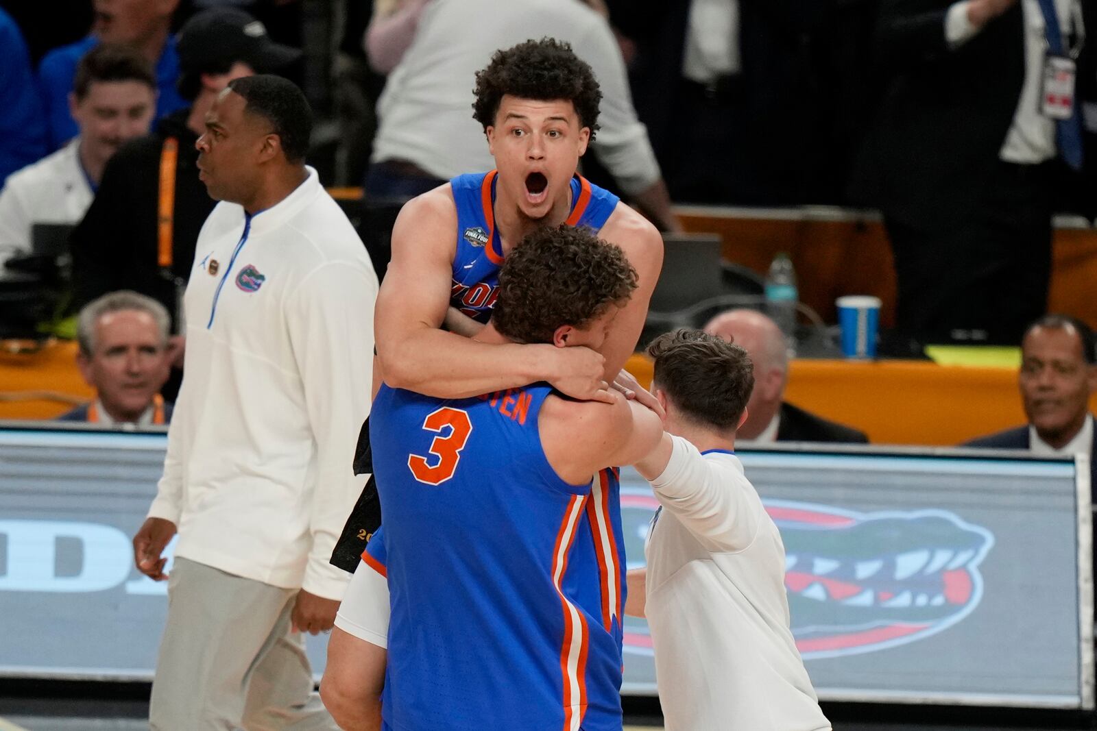 Florida's Micah Handlogten (3) and Walter Clayton Jr. celebrate after Florida beat Houston in the national championship at the Final Four of the NCAA college basketball tournament, Monday, April 7, 2025, in San Antonio. (AP Photo/Stephanie Scarbrough)