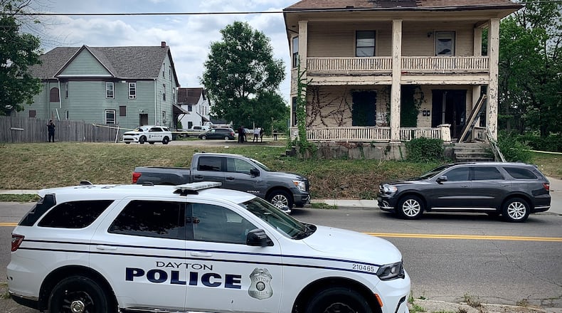 Homicide detectives at a crime scene after a male was found dead with a gunshot wound in the first block of West Helena Street in Dayton Wednesday, July 3, 2024. MARSHALL GORBY / STAFF