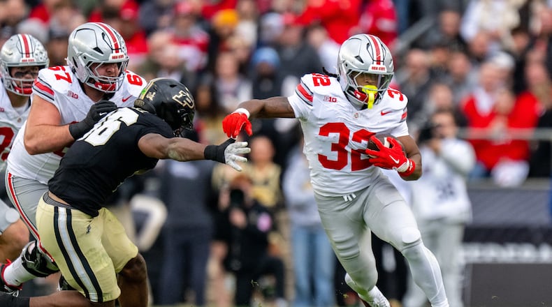 Ohio State running back Isaiah West (32) runs the ball out of the backfield during the first half of an NCAA college football game against Purdue, Saturday, Nov. 8, 2025, in West Lafayette, Ind. (AP Photo/Doug McSchooler)