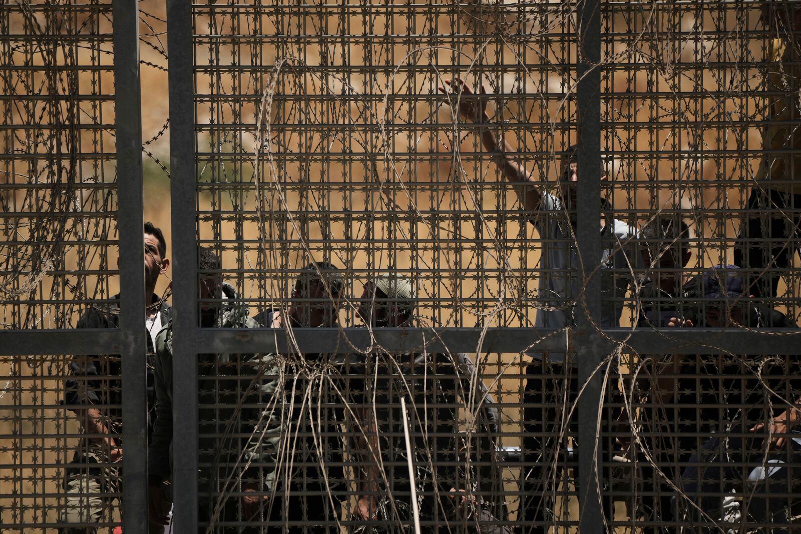 Syrian Druze protest near the Israeli-Syrian border, as seen from the town of Majdal Shams in the Israeli-controlled Golan Heights, Wednesday, July 16, 2025, amid the ongoing clashes between Syrian government forces and Druze armed groups in the southern Syrian city of Sweida. (AP Photo/Leo Correa)