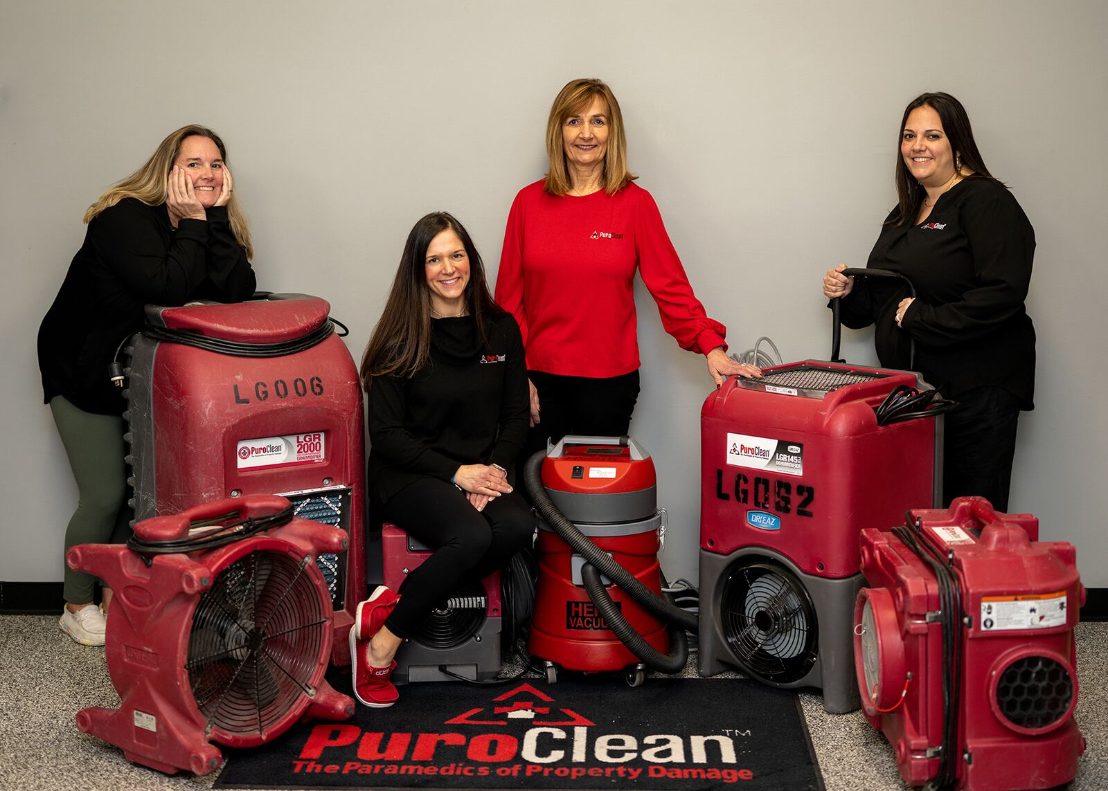 Becky Edgren (in red) owns and runs PuroClean Dayton with her daughters from left, Megann Eversole, Britni Hurst (sitting) and Lara Harshbarger. CONTRIBUTED