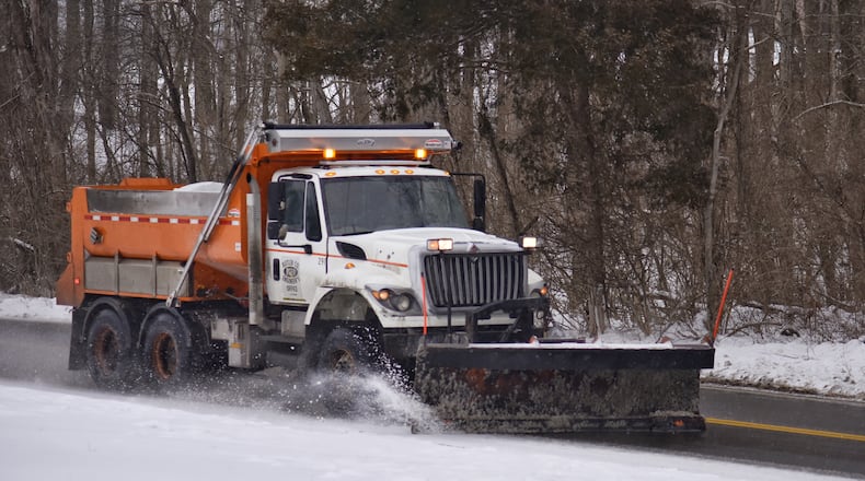 A Butler County Engineer's Office salt truck plows Elk Creek Road in Madison Township Monday, February 15, 2021. NICK GRAHAM / STAFF