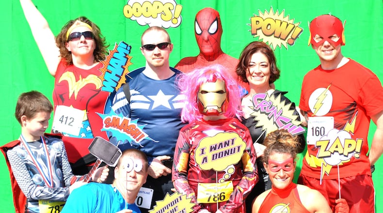 Superheroes getting ready to hit the streets for the fourth annual Superhero Donut Run benefitting A Special Wish Foundation — Dayton. CONTRIBUTED