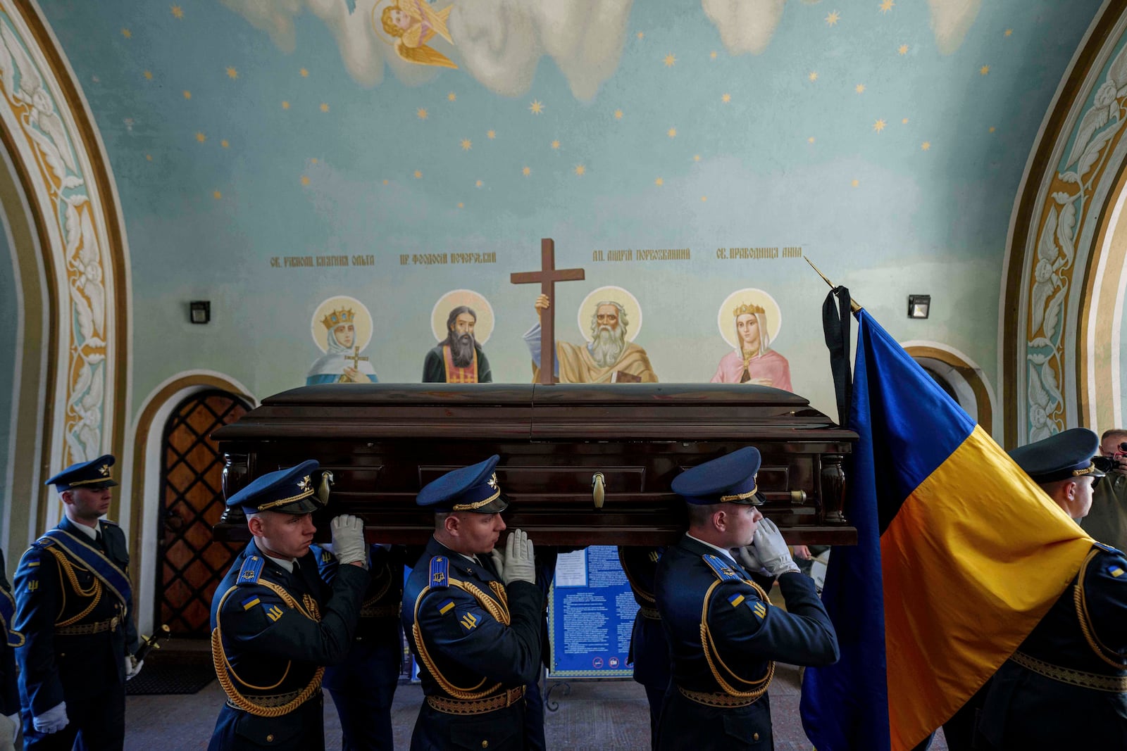 An honor guard carries the coffin of Ukrainian F-16 pilot Maksym Ustymenko, during a farewell ceremony in Kyiv, Ukraine, on Thursday, July 3, 2025. (AP Photo/Evgeniy Maloletka)