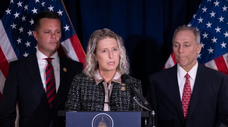 Rep. Jen Kiggans, R-Va., center, accompanied by Rep. Zachary Nunn, R-Iowa, left, and House Majority Leader Steve Scalise, R-La., right, speaks at a news conference at the Republican National Committee headquarters on Capitol Hill in Washington, Wednesday, Sept. 18, 2024. (AP Photo/Ben Curtis)