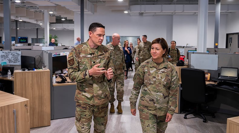 Lt. Col. Michael Lasher, Air Force Life Cycle Management Center Rapid Sustainment Office, briefs Chief Master Sgt. of the Air Force JoAnne S. Bass on the RSO mission during a tour June 16 in Dayton. Bass was in Dayton for the Corona conference at Wright-Patterson Air Force Base and took the opportunity to learn about innovative programs in the area. U.S. AIR FORCE PHOTO/R.J. ORIEZ