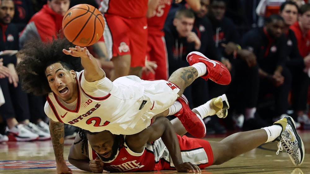 Rutgers guard Lino Mark (2) dives for a loose ball over Ohio State guard Bruce Thornton during the second half of an NCAA college basketball game Friday, Jan. 2, 2026, in Piscataway, N.J. (AP Photo/Adam Hunger)