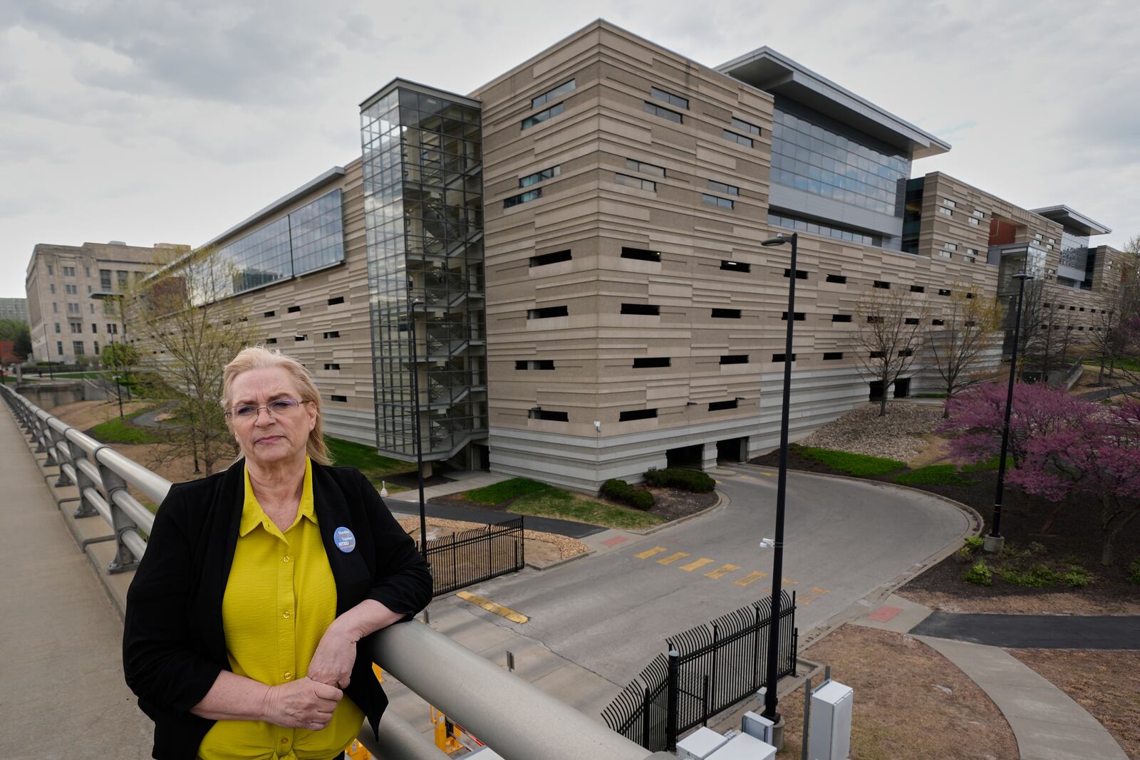 IRS customer service representative Shannon Ellis, stands outside a processing center where hundreds of her colleagues have taken buyouts and others face potential layoffs, Monday, April 14, 2025, in Kansas City, Mo. (AP Photo/Charlie Riedel)