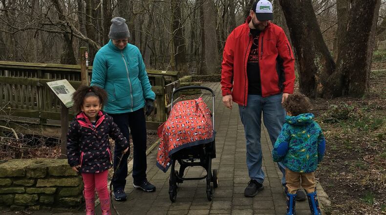 A family enjoys a break from the indoors at Wegerzyn Gardens MetroPark on Thursday. Staff photo / Sarah Franks