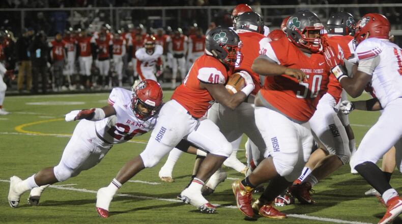 Trotwood defensive end Devon Smith (left) helped shut down Toledo Central Catholic running back Michael Warren (with ball) in a 36-0 D-III state semifinal win at Lima on Saturday, Nov. 26, 2016. MARC PENDLETON / STAFF