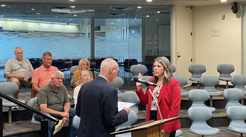 Lauren Williams (right) takes the oath of office as she is sworn in by West Carrolton Mayor Rick Barnhart (left) as the newest member of West Carrollton City Council on Tuesday, June 25. Williams fills a seat on council vacated by Amanda Zennie's May 8 resignation. CONTRIBUTED