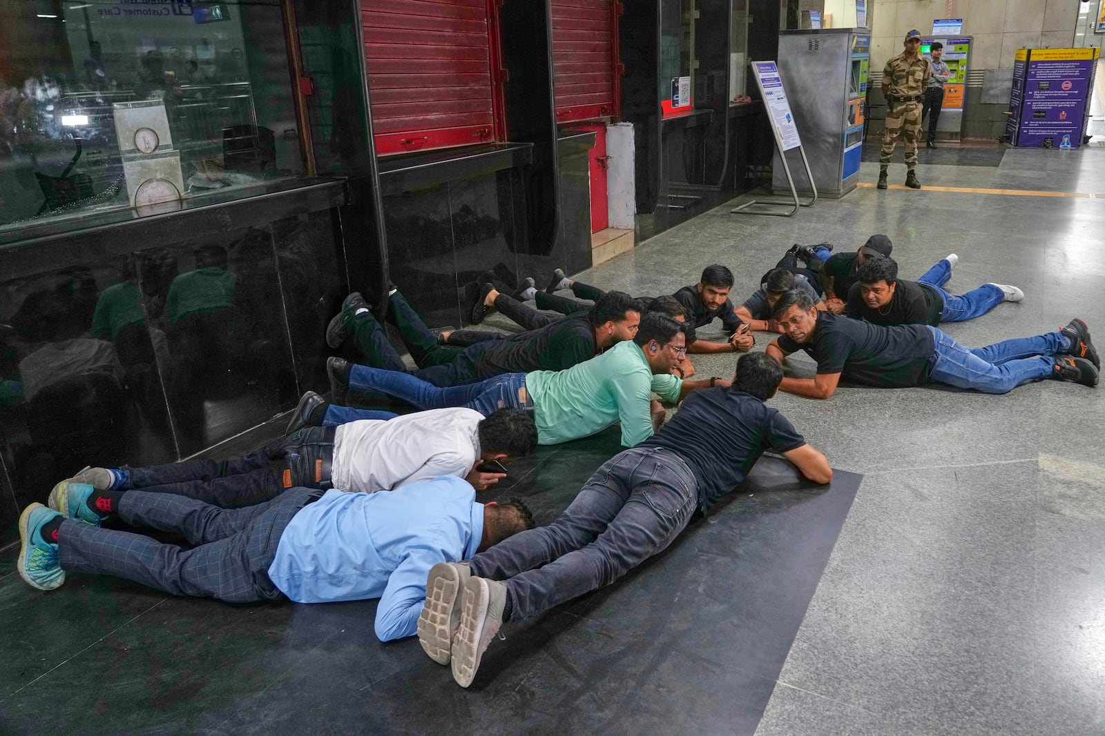 Civil defense members carry out a mock drill at a metro station to train civilians and security personnel to respond in case of attack, in New Delhi, India, Wednesday, May 7, 2025. (AP Photo/Manish Swarup)