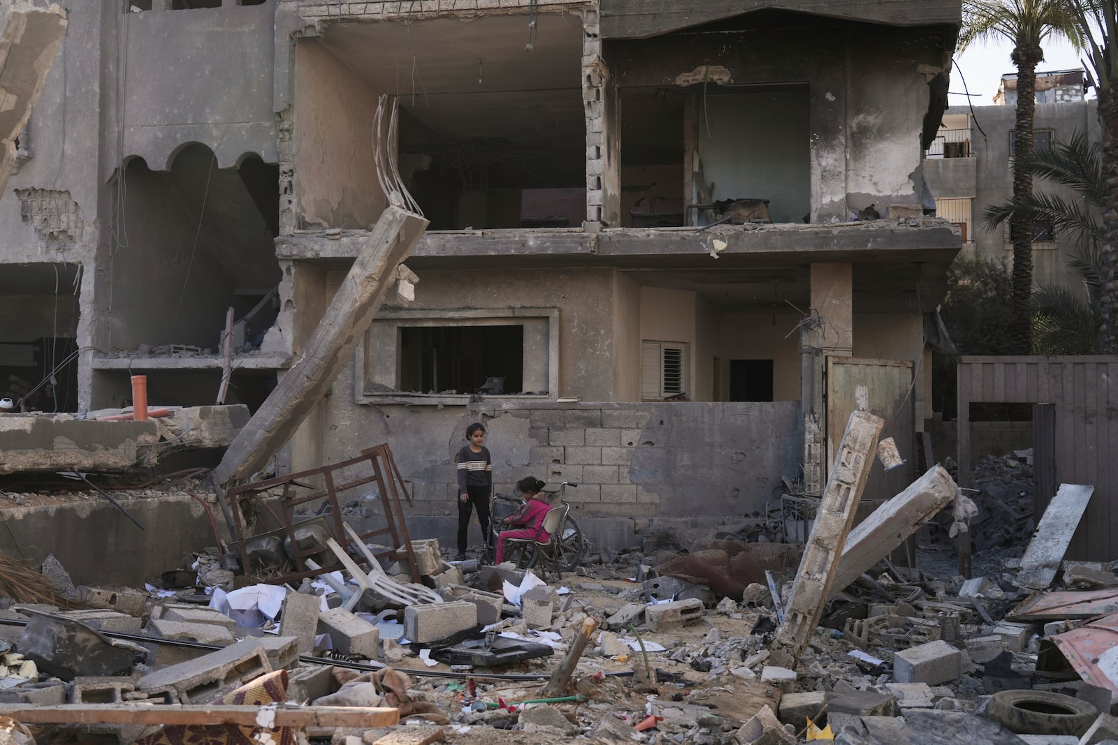 Palestinians inspect a house destroyed by an Israeli airstrikes in Deir al-Balah, Gaza, Wednesday, May 21, 2025. (AP Photo/Abdel Kareem Hana)