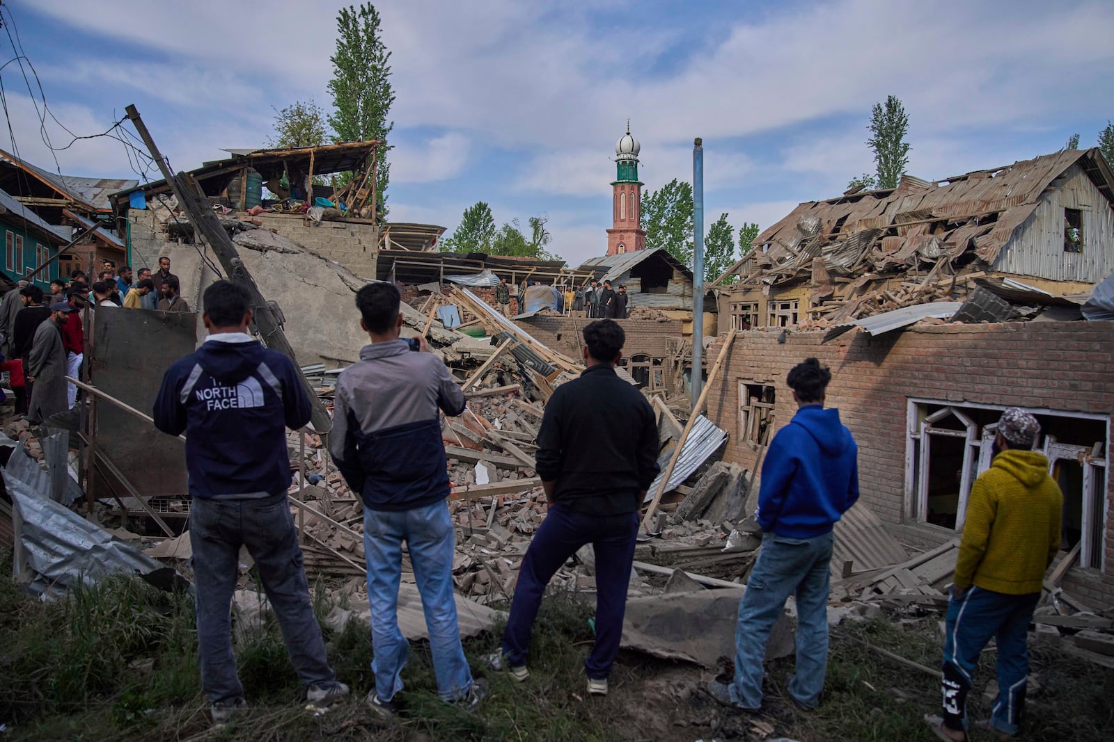 Kashmiri villagers inspect the debris of the blown-up family home of Ahsan Ul Haq Shiekh, a militant who officials say is involved in the deadly attack on tourists in Pahalgam, at Murran village in Pulwama, south of Srinagar, Indian controlled Kashmir, Saturday, April 26, 2025. (AP Photo/Dar Yasin)