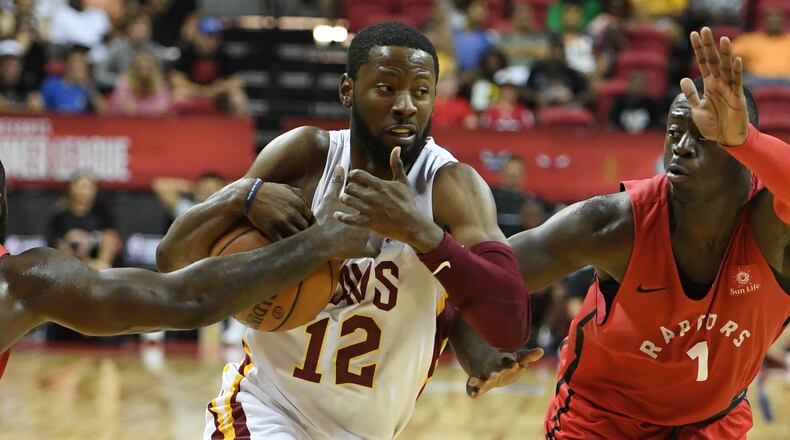 LAS VEGAS, NV - JULY 15:  Scoochie Smith #12 of the Cleveland Cavaliers drives between Giddy Potts #20 and Rawle Alkins #1 of the Toronto Raptors during a quarterfinal game of the 2018 NBA Summer League at the Thomas & Mack Center on July 15, 2018 in Las Vegas, Nevada. The Cavaliers defeated the Raptors 82-68. NOTE TO USER: User expressly acknowledges and agrees that, by downloading and or using this photograph, User is consenting to the terms and conditions of the Getty Images License Agreement.  (Photo by Ethan Miller/Getty Images)