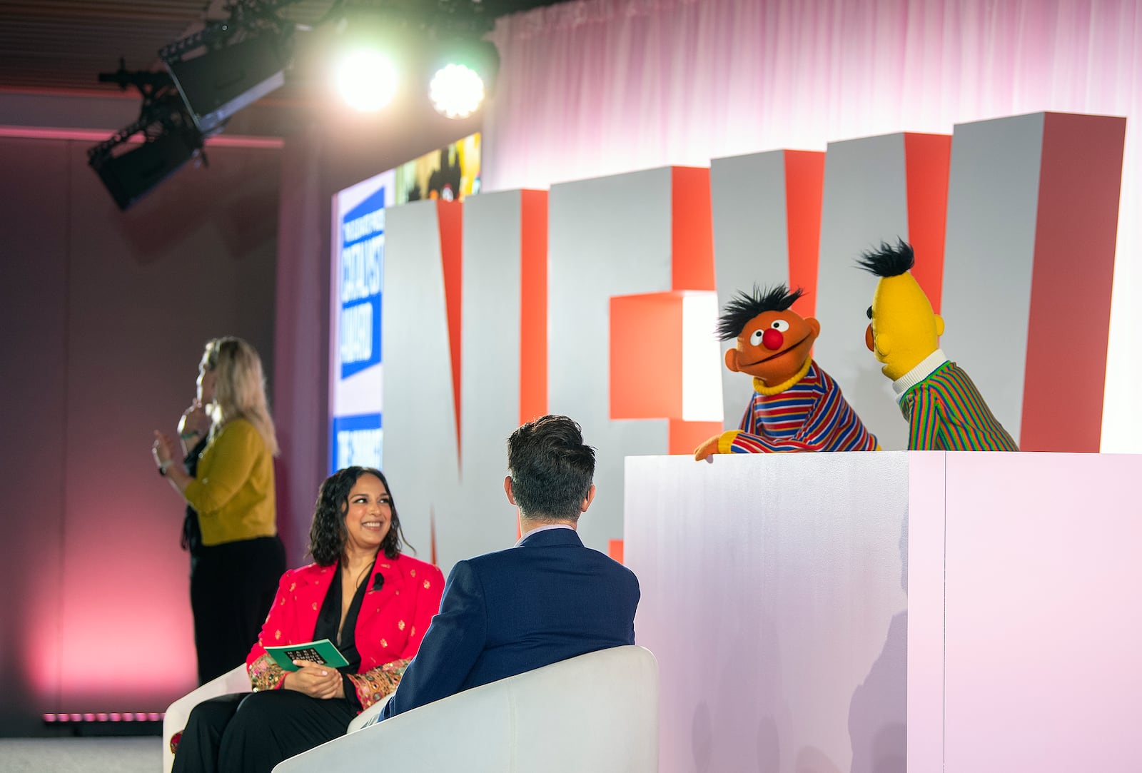 Sal Perez, executive producer and VP of Sesame Street at Sesame Workshop, right, and Versha Sharma, editor-in-chief at Teen Vogue, talk to Burt and Ernie after Sesame Workshop won the Elevate Prize Foundation's Catalyst Award, Wednesday, May 14, 2025, in Miami Beach, Fla. (AP Photo/Michael Laughlin)