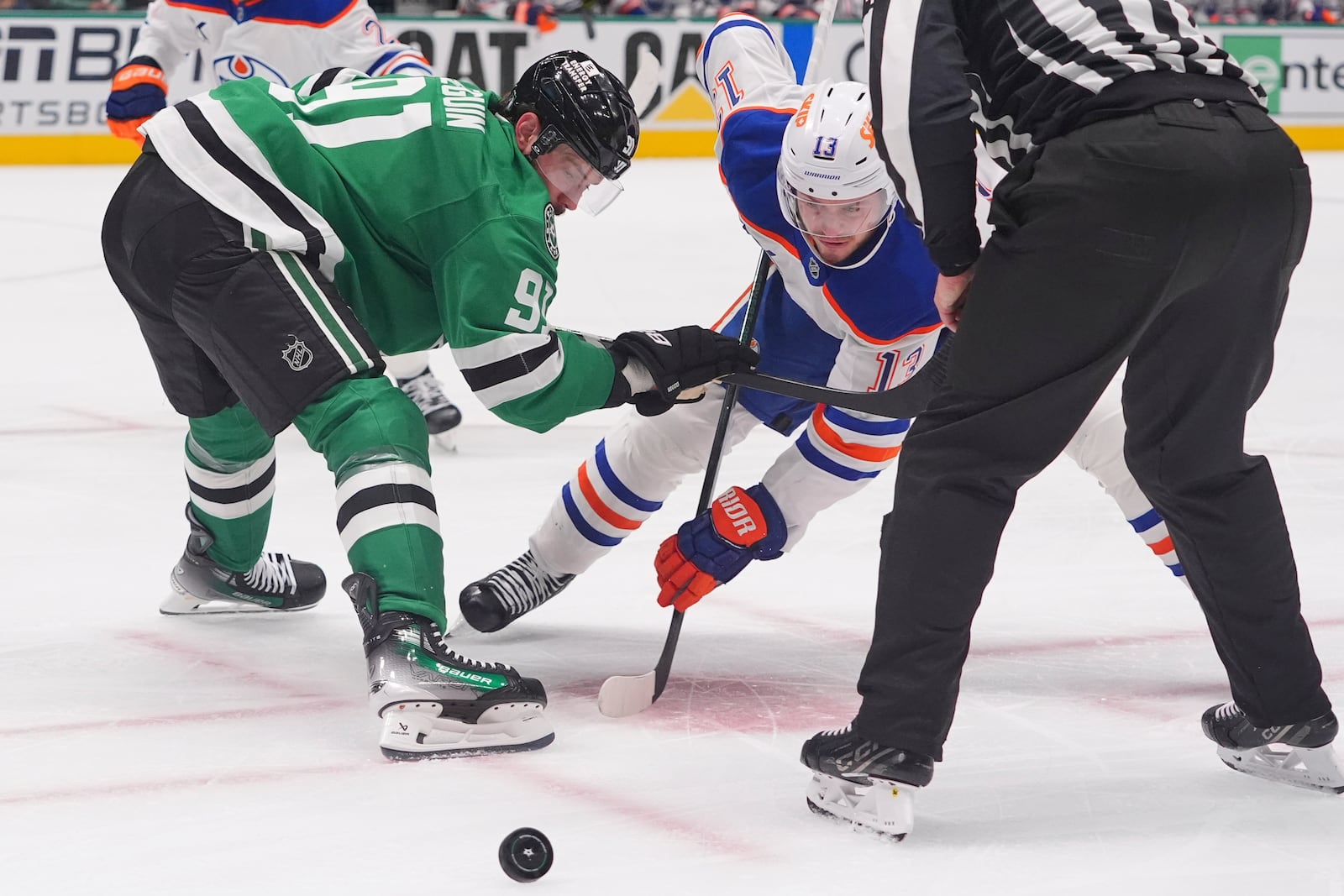 Dallas Stars center Tyler Seguin (91) and Edmonton Oilers center Mattias Janmark (13) face-off for the puck during the second period in Game 1 of the Western Conference finals in the NHL hockey Stanley Cup playoffs Wednesday, May 21, 2025, in Dallas. (AP Photo/LM Otero)