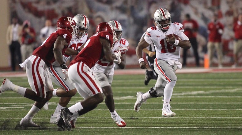 Ohio State's J.T. Barrett carries the ball against Indiana on Thursday, Aug. 31, 2017, at Memorial Stadium in Bloomington, Ind.