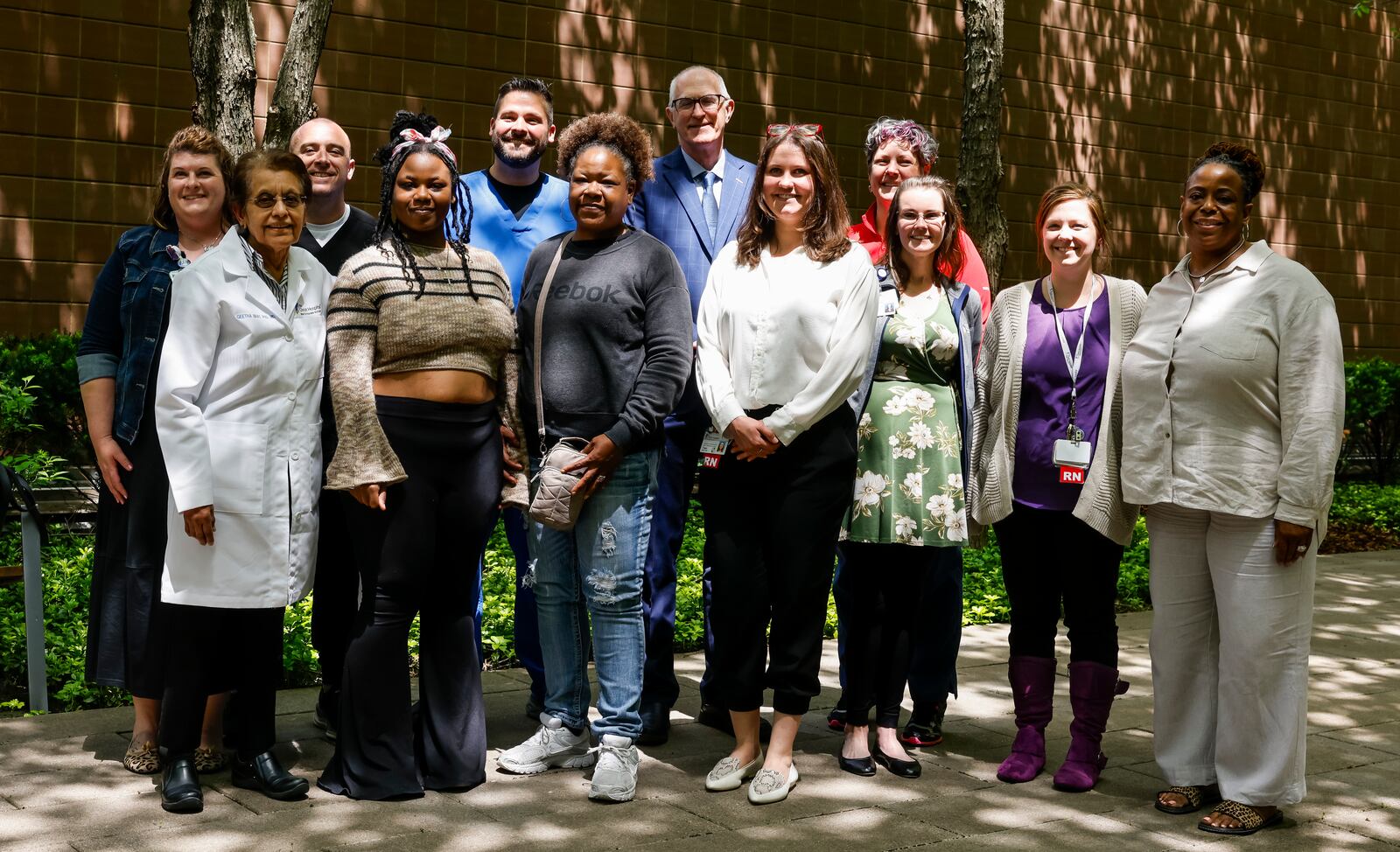 Shania Woods-Hicks, a 20-year-old from Dayton, stands with family an, doctors, nurses and more who were part of her journey to get a heart transplant at Christ Hospital in Cincinnati. NICK GRAHAM/STAFF