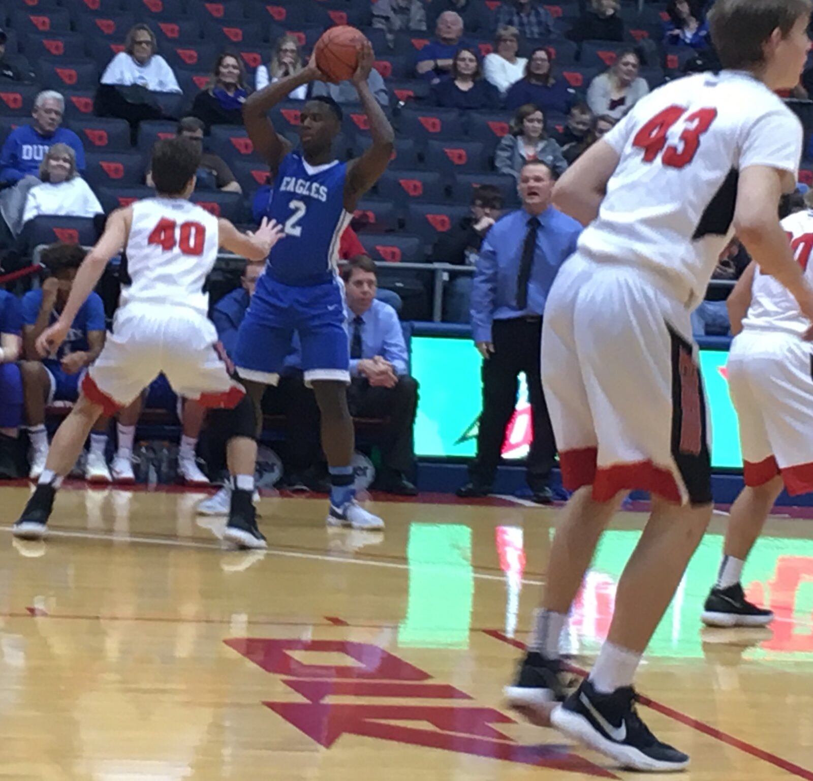 Middletown Christian’s Dre Shores (2) is guarded by Fort Loramie’s Mason Kemper (40) as MCS coach Jason Crider looks on during Friday night’s Division IV district final at the University of Dayton Arena. RICK CASSANO/STAFF
