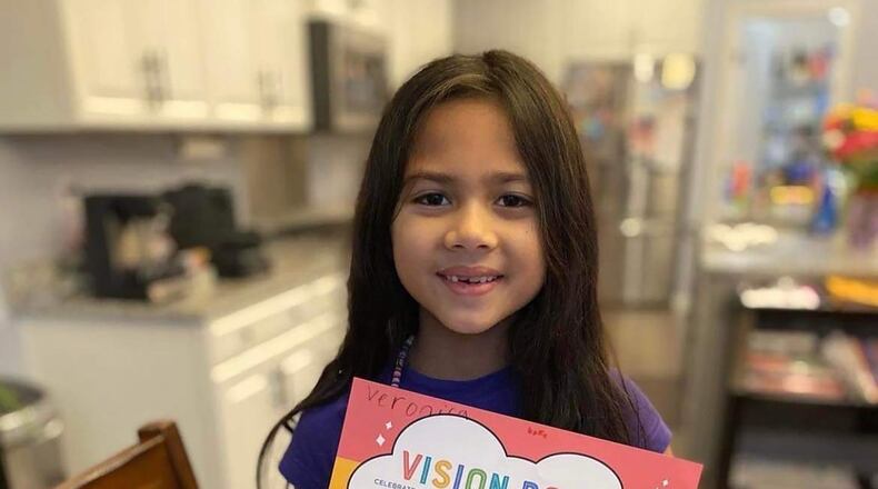 Veronica Dehner shows off her vision board, which earned her a prize of $2022 in a national contest, sponsored by Goldfish Swim School to help make her "dreams come true."