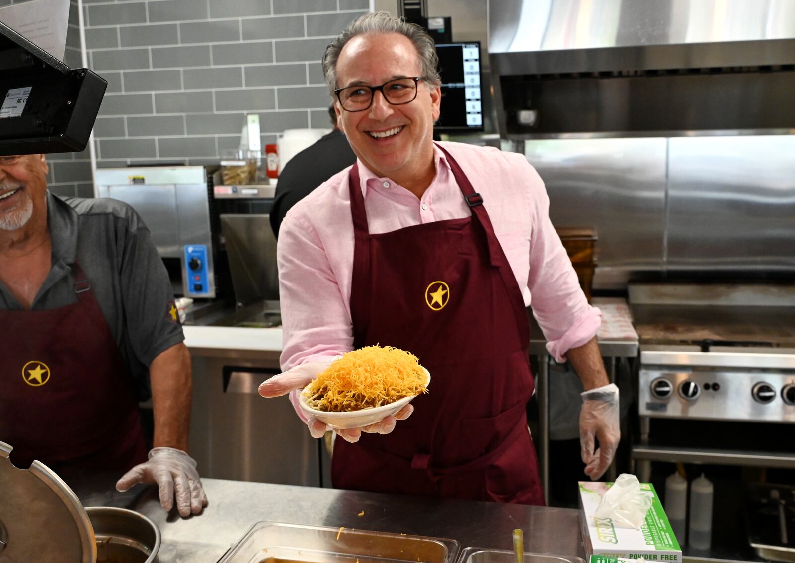 Gold Star CEO Roger David shows off a three-way following the ribbon cutting opening of the new westside Gold Star restaurant on Friday, June 6, 2025. This store replaces the one on Main Street that was owned by franchisee Carlo Salem, who is retiring. This new store will be corporate-owned. The store had been opened since late May, and will offer a community celebration weekend in early August. MICHAEL D. PITMAN/STAFF