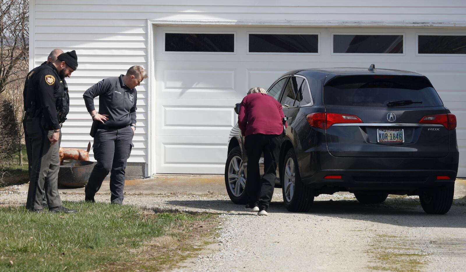 The Clark County Sheriff's Office investigates a shooting at a home in the 7000 block of South Charleston-Clifton Road Monday, March 25, 2024. Deputies arrived at the home to find a woman shot in the driveway and an 81-year-old man with injuries. The woman was flown by MedFlight to Kettering Health Main Campus, where she later died, while the man was transported to the hospital by medic. BILL LACKEY/STAFF