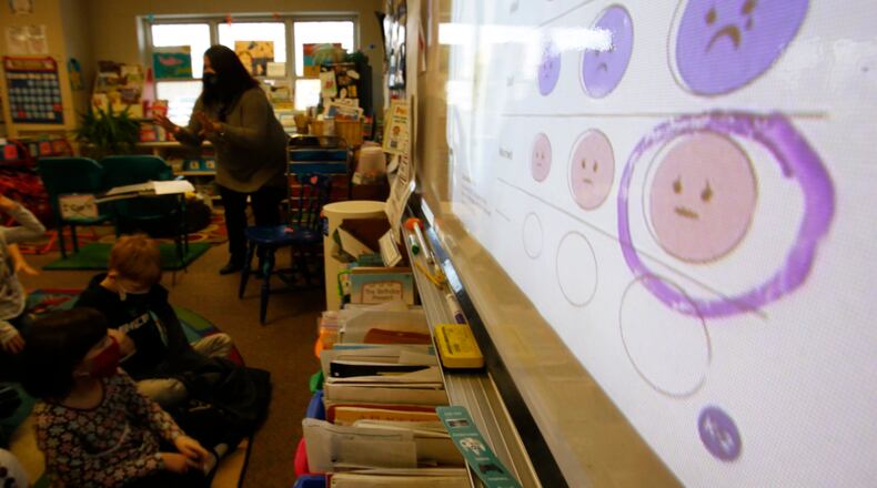 FILE - Second-grade teacher Melissa Shugg teaches a lesson at Paw Paw Elementary School about thoughts, feelings and actions on Dec. 2, 2021, in Paw Paw, Michigan. Shugg is one of many teachers at the school who've been trained to teach a social-emotional curriculum created at the University of Michigan called TRAILS. Research suggests TRAILS lessons for at-risk kids can reduce depression and improve coping skills — something district officials say has been particularly important during the pandemic. (AP Photo/Martha Irvine, File)