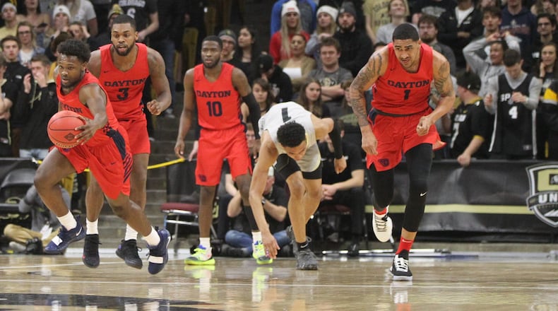 Dayton’s Jordan Davis picks up a loose ball against Colorado in the first round of the NIT on Tuesday, March 19, 2019, at the CU Events Center in Boulder, Colo. David Jablonski/Staff