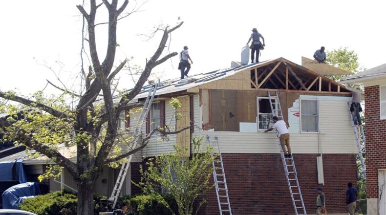 Home in Trotwood’s Westbrooke neighborhood on Greenbrook Drive are being repaired. TY GREENLEES / STAFF