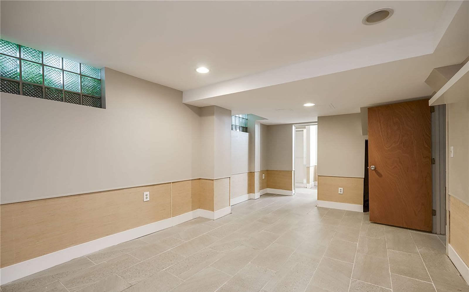 The finished basement has a rec/family room with tile flooring, glass block windows and recessed lighting. There is a full bathroom in the basement.