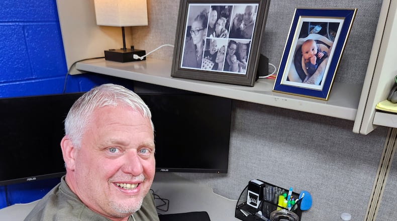 Michael Wise at his desk at Five Star Services where he was hired in 2020 to be a warehouse manager despite having multiple felony convictions and no high school diploma or GED. He is in recovery after spending decades addicted to drugs. The photos on his desk are of wife Amanda and their son Preston, now 20 months old. CONTRIBUTED
