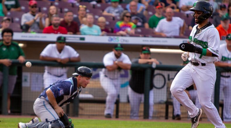 Francisco Urbaez scores the second run in a six-run first inning on a single by Victor Ruiz during Thursday night's game against West Michigan at Day Air Ballpark. Jeff Gilbert/CONTRIBUTED