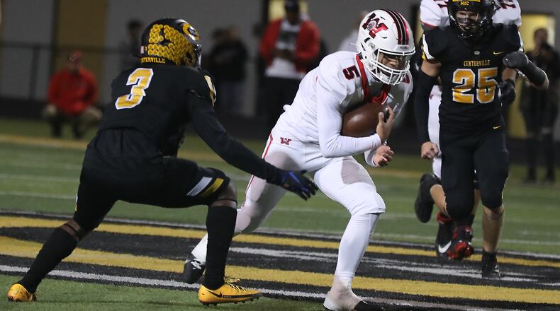 Wayne's Tyrell Lewis tries to avoid a tackle by Centerville's Reggie Powers during Friday's game. BILL LACKEY/STAFF