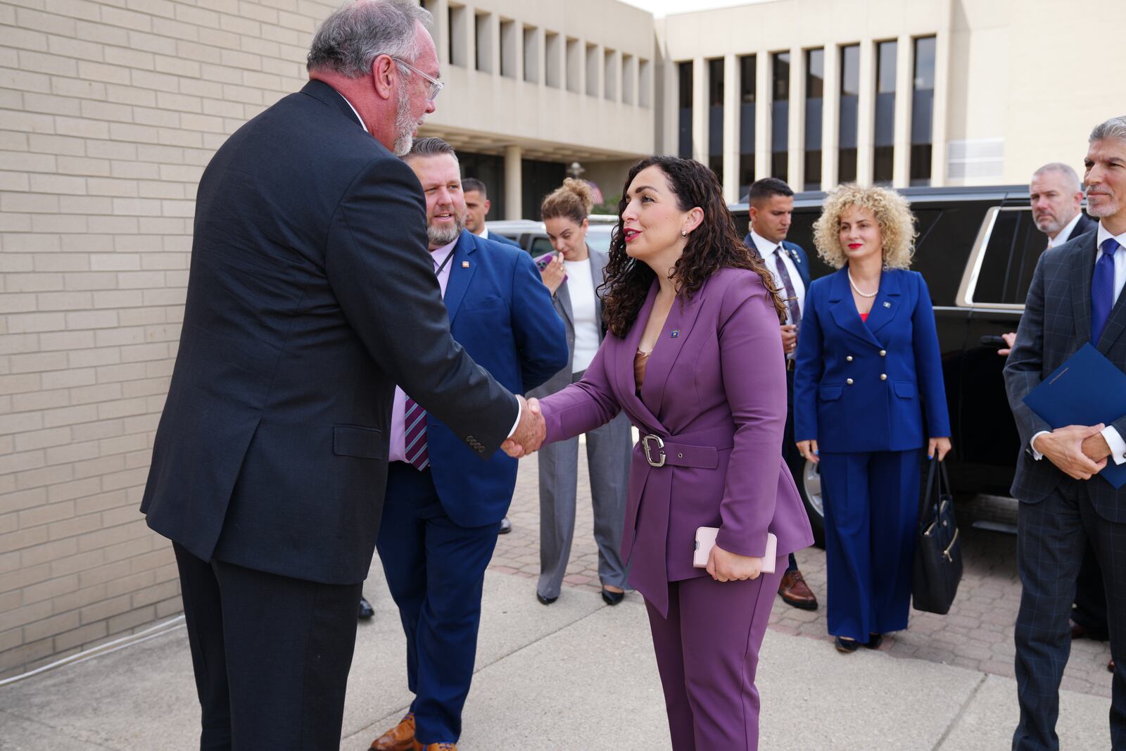 Sinclair Community College President and CEO Steven Johnson shakes hands with Kosovo President Vjosa Osmani on the college’s campus in downtown Dayton . CONTRIBUTED