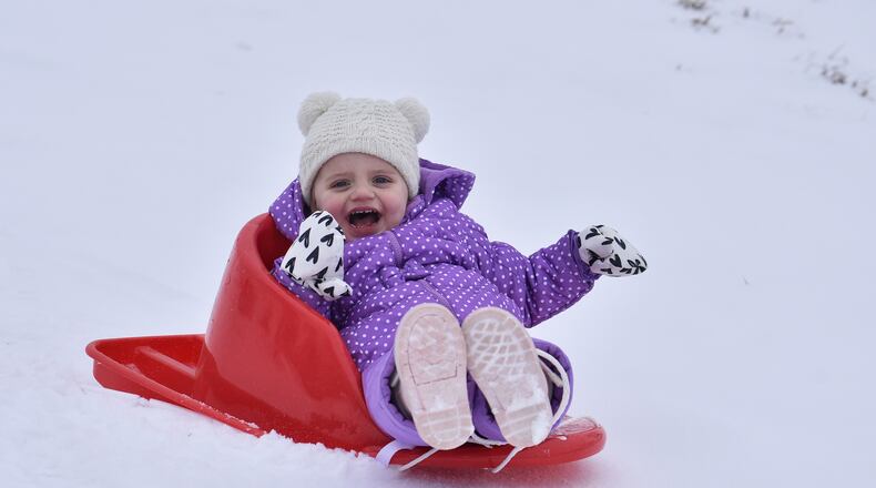 Emmie Colliver, 2, sleds down a hill at St. John XXIII Catholic School Monday, Feb. 15, 2021 in Middletown. NICK GRAHAM / STAFF